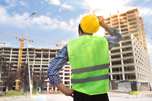 istock Young Engineer portrait with construction site and crane background. 1045632722