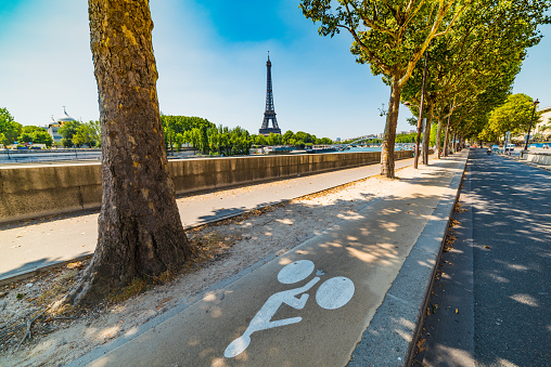 Bike lane by Seine river with world famous Tour Eiffel on the background. Paris, France
