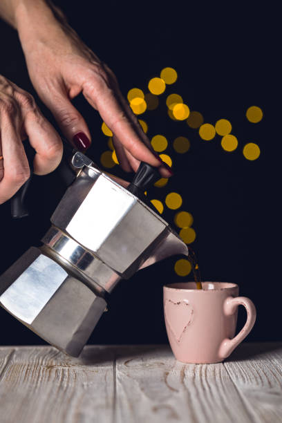 istock girl pours coffee from a geyser coffee maker into a cup 1045637904