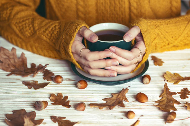 girl is holding a cup of tea in hands