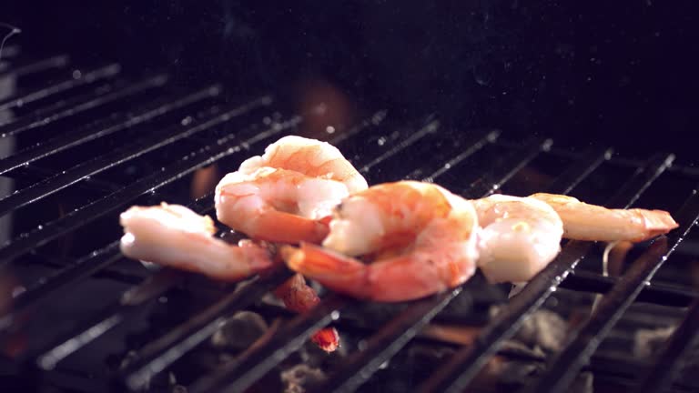 Shrimp falling on grill