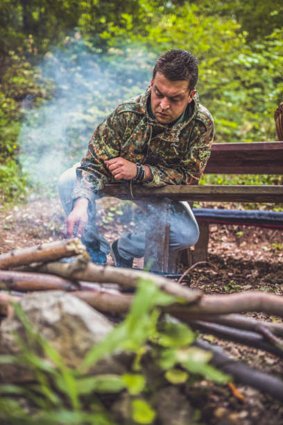 istock Preparing food on grill in forest 1045662346