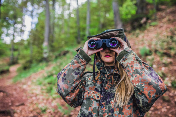 istock Camouflage woman scout in forest 1045664642