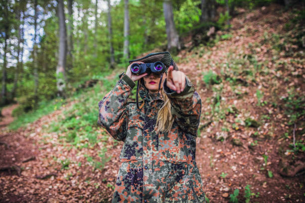 istock Camouflage woman scout in forest 1045664694