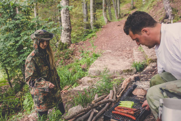 istock Preparing food on grill in forest 1045664874
