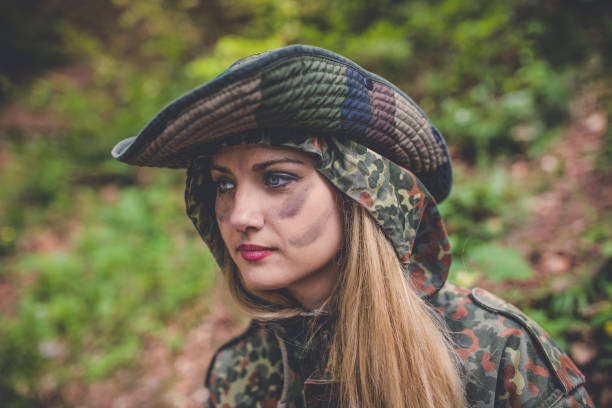 istock Camouflage woman in the forest 1045667090