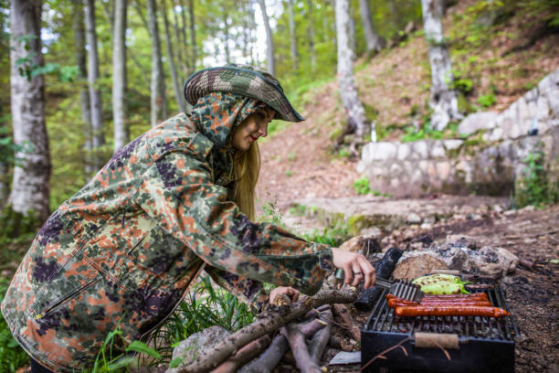 istock Preparing food on grill in forest 1045671936