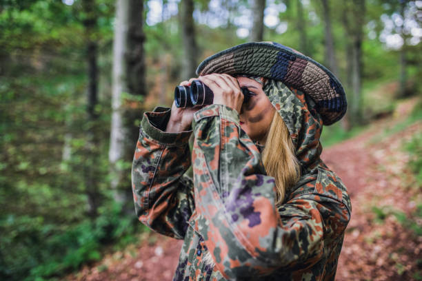 istock Camouflage woman scout in forest 1045671956