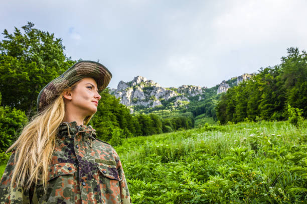 istock Camouflage woman in the forest 1045674026