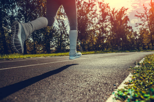 istock Young woman running on stadium track 1045696074