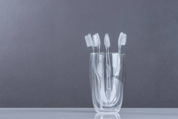 istock New Toothbrush  in glass on gray 1045696170