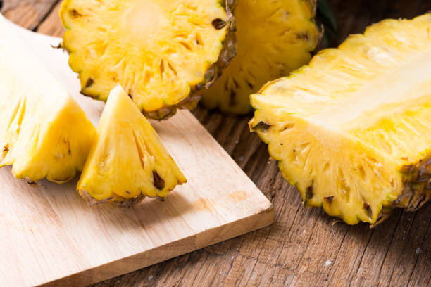 istock pineapple on the wood  background 1045696276