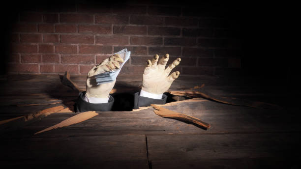 istock Zombie hand through hole cracked in rustic wood.Halloween theme 1045707732