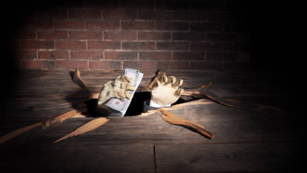 istock Zombie hand through hole cracked in rustic wood.Halloween theme 1045707736
