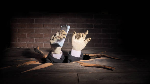Zombie hand through hole cracked in rustic wood.Halloween theme