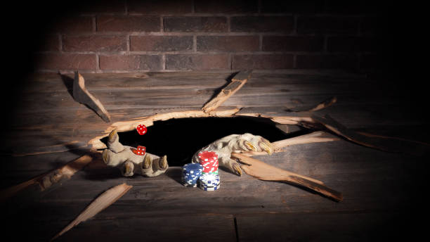 istock Zombie hand through hole cracked in rustic wood.Halloween theme 1045707824