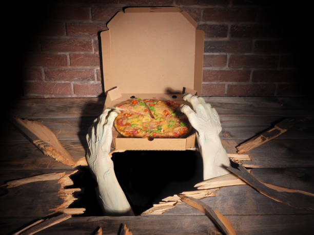 Zombie hand through hole cracked in rustic wood.Halloween theme