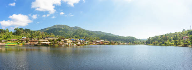 istock Panoramic village and lake with mountians 1045712472