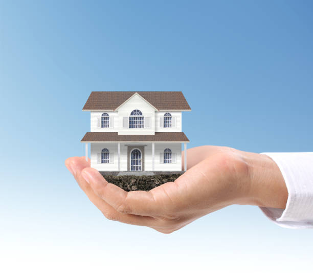 istock Mortgage concept by house  in hand 1045732346