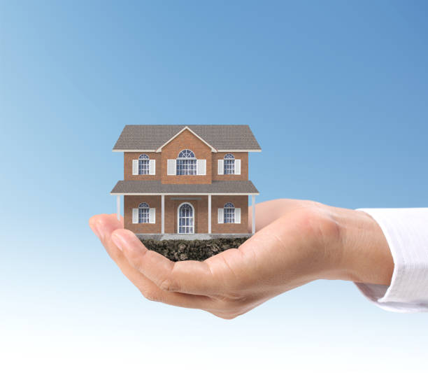 istock Mortgage concept by house  in hand 1045732348