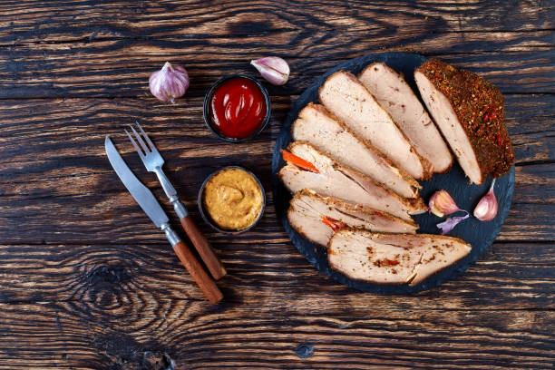 istock Homemade baked ham on a wooden table, top view 1045735070