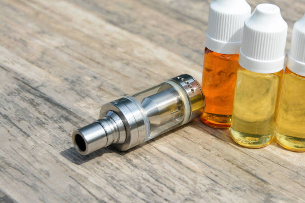 istock E - cigarette for vaping , technical devices.The liquid in the bottle 1045737852