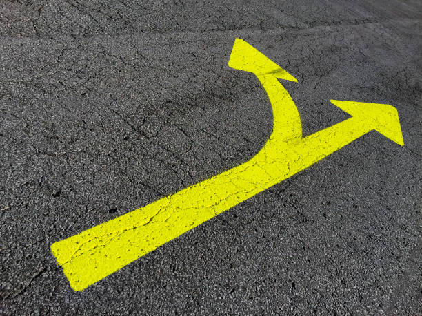 istock Yellow Double-Headed Arrows on Road Pavement 1045742206