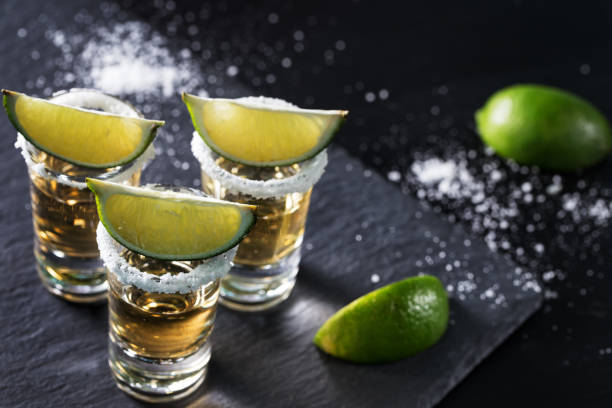 istock Golden tequila on black background 1045764502