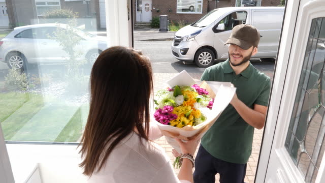4K: Man delivers Bouquet of Flowers to a woman at her home - Front door