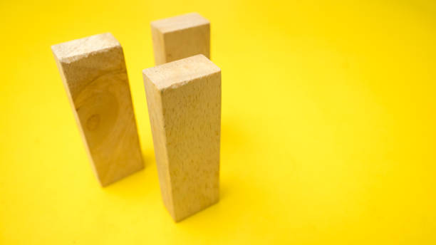 istock wood block on yellow background 1045792674