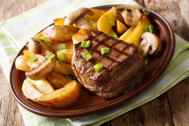 istock fillet mignon with fried potatoes and mushrooms close-up on a plate. horizontal 1045802322