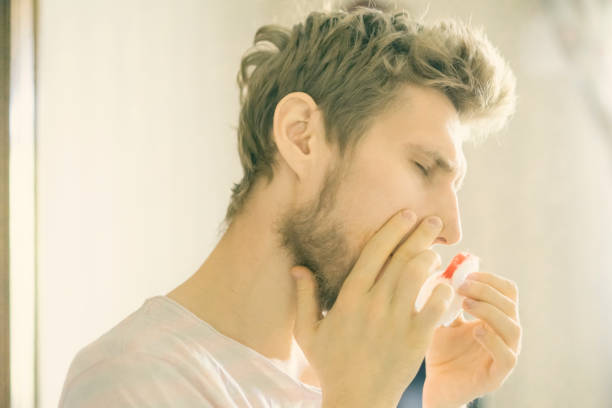 istock close up bearded  man portrait suffer from nose bleed using wadding tampon f 1045802518