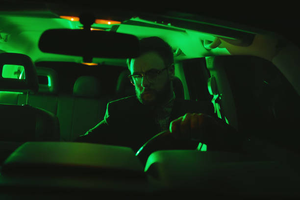 istock Businessman sitting in the car at night 1045809200