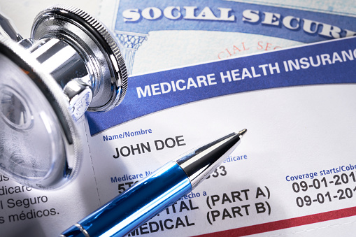 Medicare Health Insurance Card. Social Security Card with Stethoscope and pen