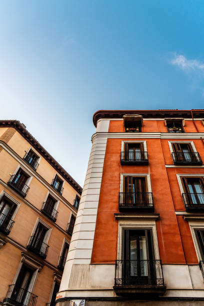 Colorful old buildings in Madrid, Spain. Low angle view against blue sky with space for copy