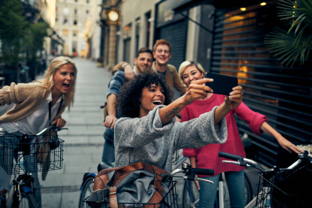 istock Friends Riding Rented Bicycles In A City 1045815526