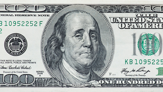 Concept showing devaluation of american dollars by Quantitative easing program - crying Benjamin Franklin