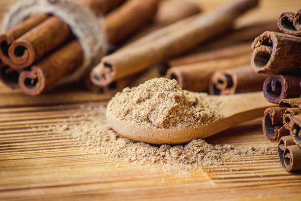 istock ground cinnamon and sticks on a wooden background. selective focus. 1045822392