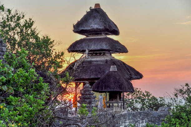 Pura Luhur Uluwatu Temple at sunset on Bali Uluwatu is a place on the south-western tip of the Bukit Peninsula of Bali, Indonesia tanah lot sunset stock pictures, royalty-free photos & images