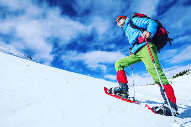 schneeschuh-walker im pulverschnee mit wunderschönen sonnenaufgang licht ausgeführt. outdoor-winter-aktivität und eine gesunde lebensweise - tea island stock-fotos und bilder