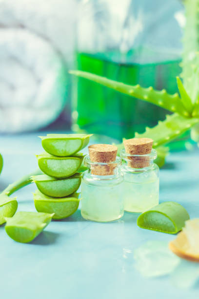 istock Aloe Vera extract in a small bottle and pieces on the table. Selective focus. 1045838396