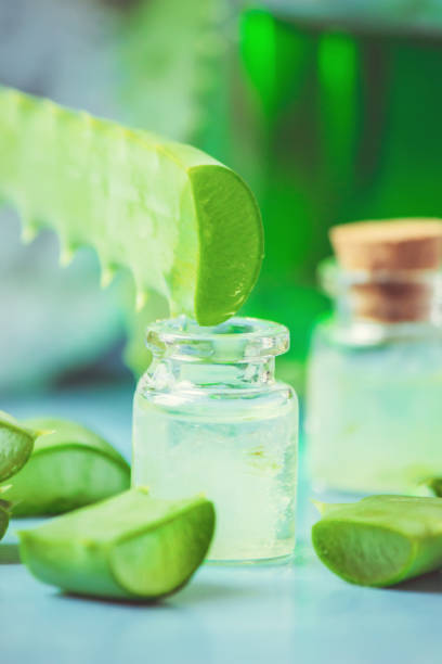 istock Aloe Vera extract in a small bottle and pieces on the table. Selective focus. 1045838476