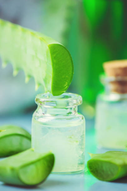 istock Aloe Vera extract in a small bottle and pieces on the table. Selective focus. 1045838500