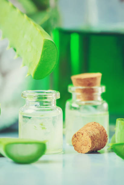 istock Aloe Vera extract in a small bottle and pieces on the table. Selective focus. 1045838548
