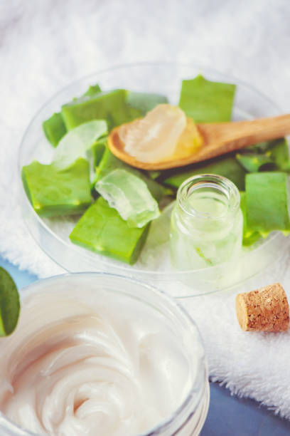 istock Aloe Vera extract in a small bottle and pieces on the table. Selective focus. 1045838614