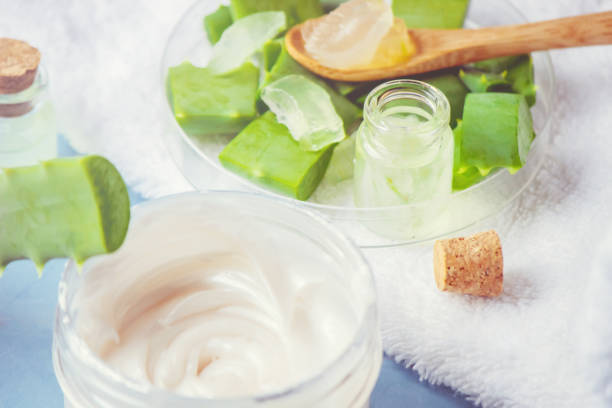istock Aloe Vera extract in a small bottle and pieces on the table. Selective focus. 1045838658