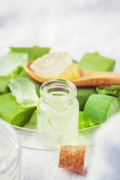 istock Aloe Vera extract in a small bottle and pieces on the table. Selective focus. 1045838664