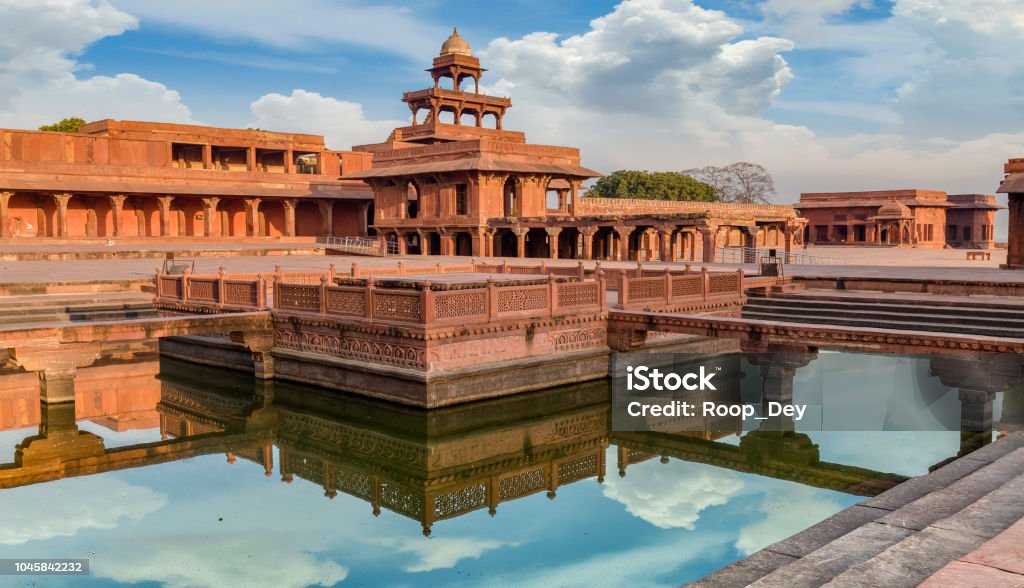 Fatehpur Sikri Anup Talao is a red sandstone architectural structure with a pool connected with four bridges used for Medieval concerts. Fatehpur Sikri is a beautifully crafted red sandstone fort city and a classic example of Mughal architecture in India. A UNESCO World Heritage site at Agra, Uttar Pradesh, India. Fatehpur Sikri Stock Photo