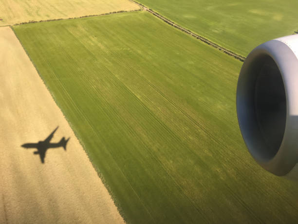 Shadow of large airplane over field