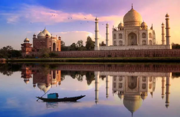 Photo of Taj Mahal Agra India at sunset with mirror reflection and vibrant sky. Taj Mahal is located at the banks of river Yamuna.